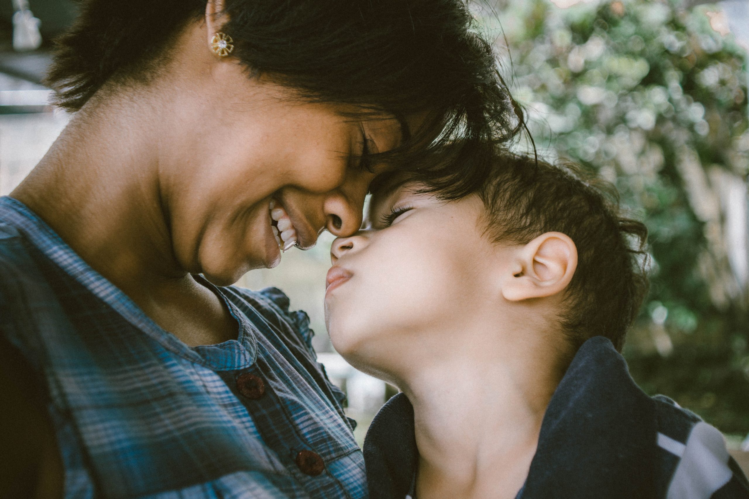 Mom smiling and touching heads with her child